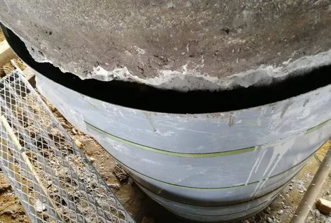 Bridge substructure rehabilitation using underwater grout and fiberglass sleeve system